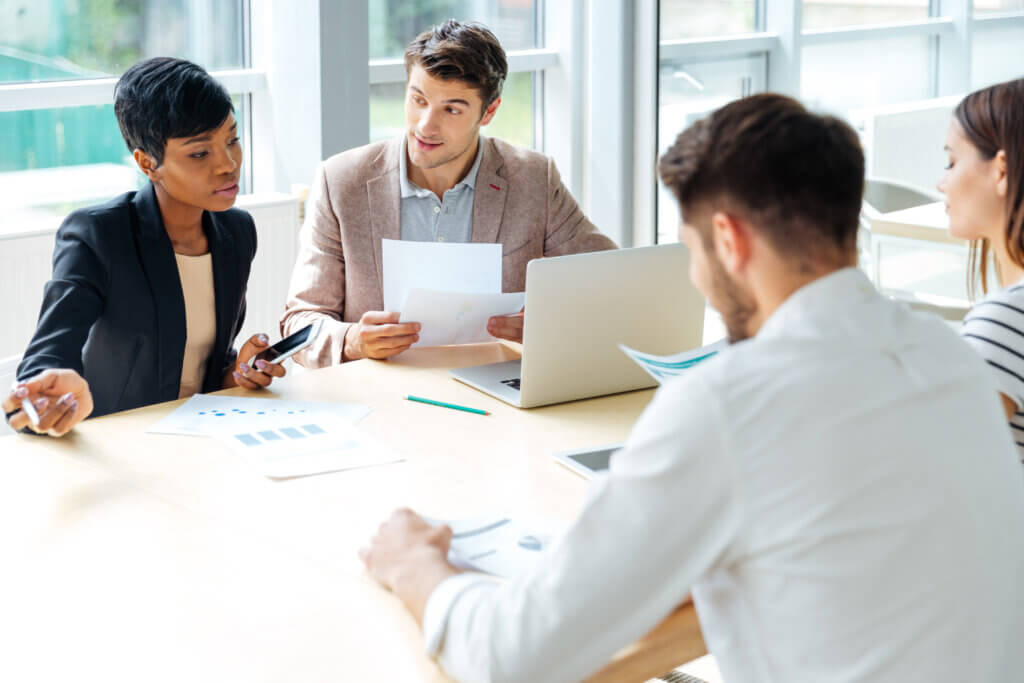 graphicstock multiethnic group of young businesspeople working together on business meeting in conference room r fwTfQB2l1